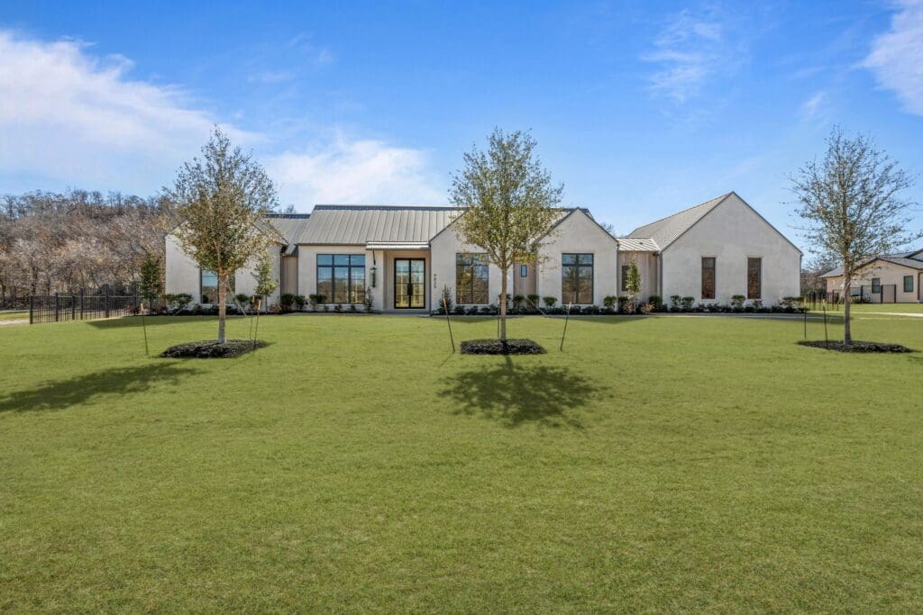 Clean lines, a metal roof, and expansive windows give 9825 Loire Valley Trail a soft contemporary edge within the gates of Montrachet. (Courtesy)