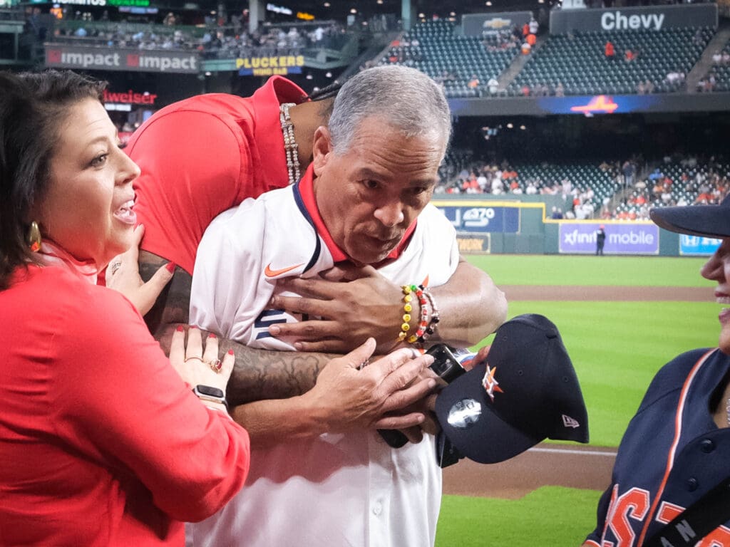 J'Wan Roberts wrapped University of Houston coach Kelvin Sampson up in a big hug. (Photo by F. Carter Smith)