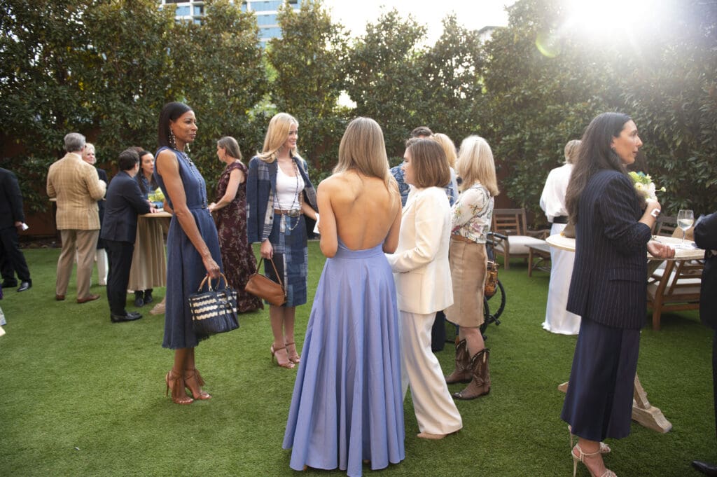 Upon arrival at The Mansion, guests enjoyed cocktails on the lawn as fresh-faced models showcased the spectacular collection. (Photo by Tamytha Cameron)