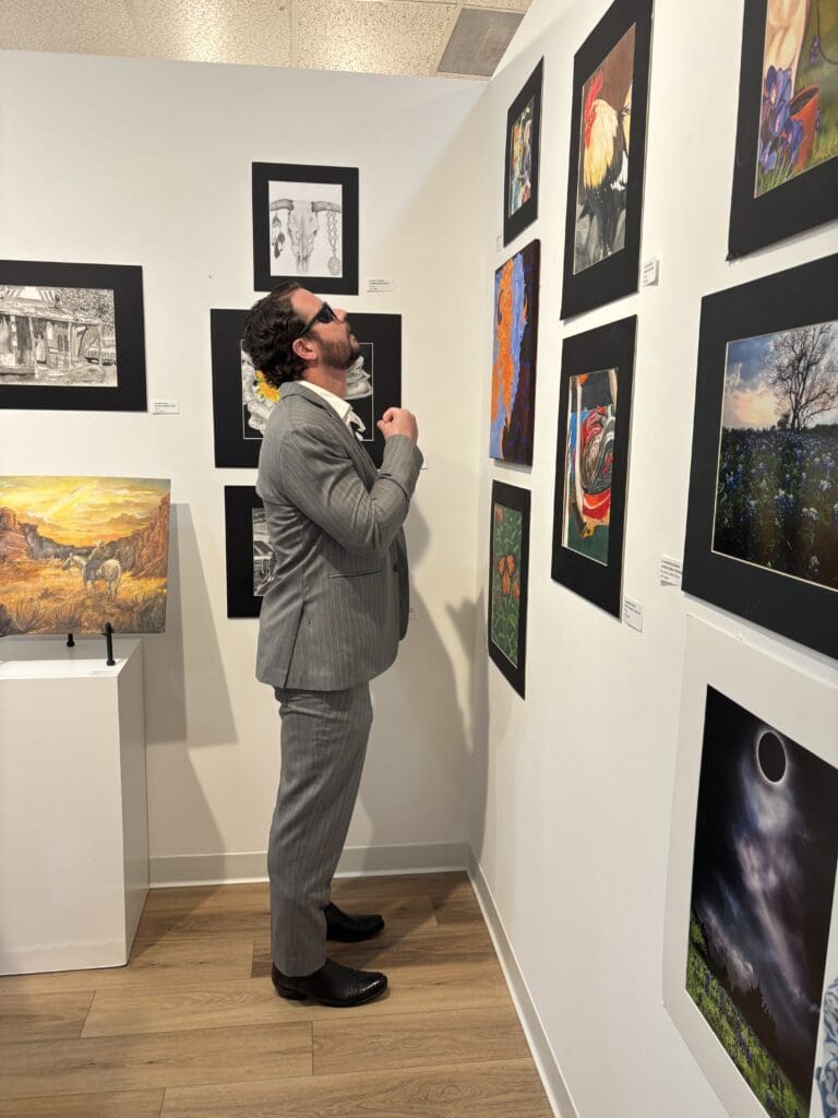 Congressman Dan Crenshaw carefully studied each of the 52 submitted pieces of art. (Photo by Laura Landsbaum)