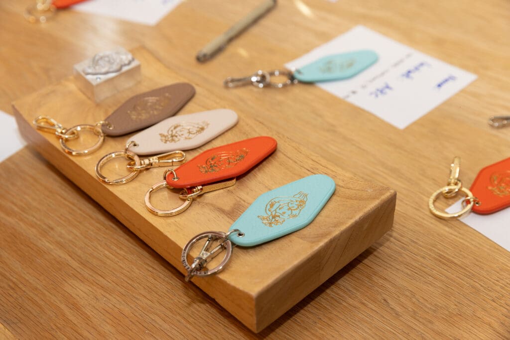 Leatherology was onsite customizing leather keychains that featured Madeline Donahue's artwork with guests' monograms. (Photo by Kaitlin Saragusa Photography)