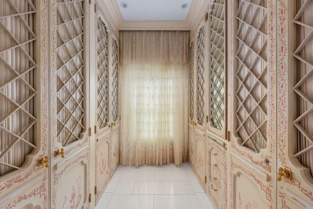 Hand-painted wardrobes from Jacqueline Kennedy Onassis’ New York apartment bring personal history and timeless detail to the dressing area.  (Photo by Freeze Media FW)