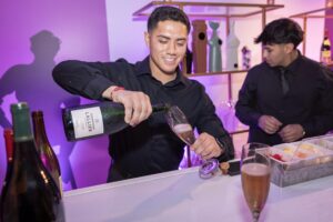 Bartender pours Lallier Champagne (Photo by Thomas Garza and Tamytha Cameron)
