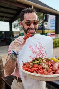Fady Armanious of Tootsies enjoying crawfish at CrawFest; photo courtesy of Cotton Holdings, Inc. (Photo by courtesy of Cotton Holdings)