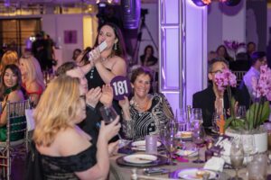 Melinda Jackson bids at auction (Photo by Thomas Garza and Tamytha Cameron)