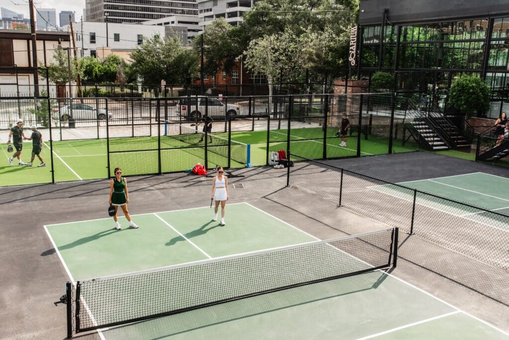 Built with four outdoor pickleball courts and two padel courts, the aptly named Solarium is a 9,000-square-foot multi-level playground with a restaurant and bar built within its soaring glass walls. (Photo by Becca Wright)