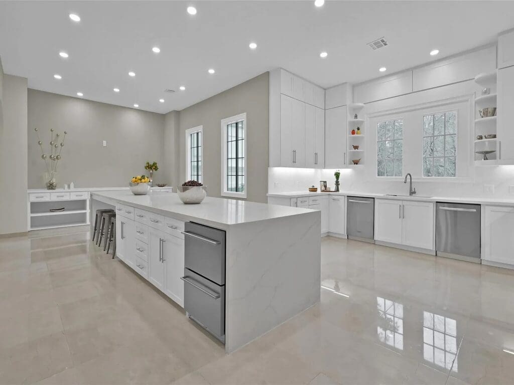 A kitchen with clean lines and an enormous island makes this a great gathering spot.