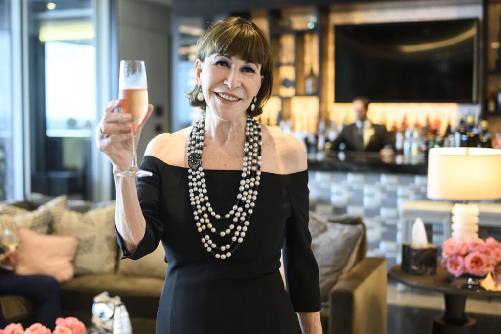 Carolina Herrera party co-host Shelby Hodge toasts the elegant fashion soirèe in the storied penthouse suite of The Post Oak Hotel  (Photo by Michelle Watson (CatchLightGroup.com))