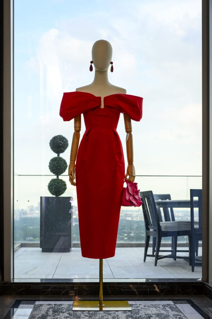 A stunning red gown in the Carolina Herrera trunk show presented in the penthouse suite of the Post Oak Hotel (CatchLightGroup.com)) (Photo by Michelle Watson, CatchLightGroup.com)