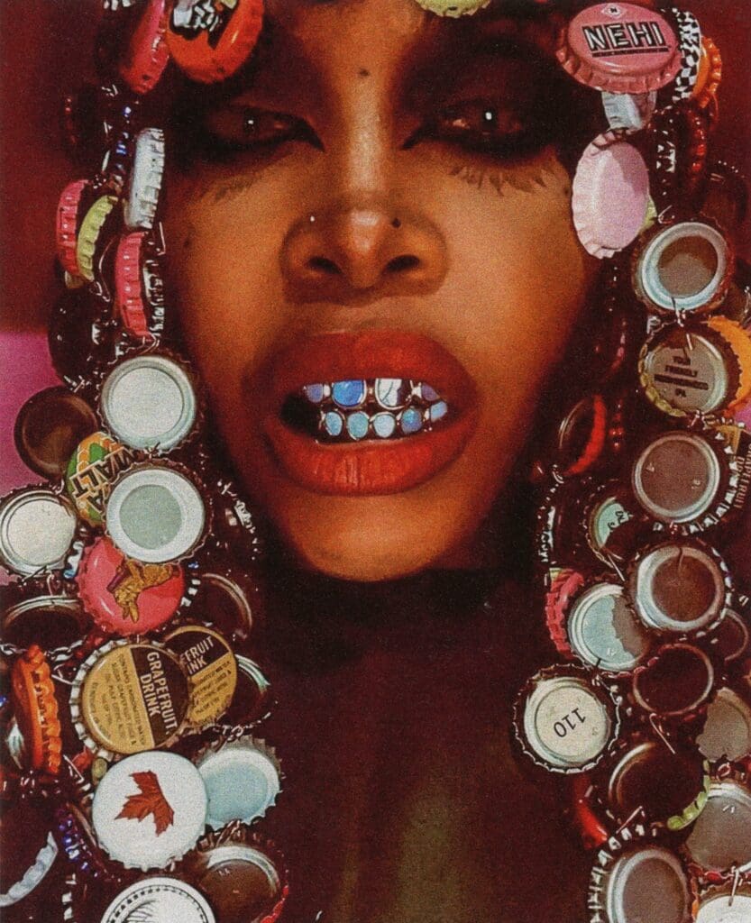 Erykah Badu in blue Australian opal grillz by Lillian Shalom, 2019 (From "Ice Cold: A Hip-Hop Jewelry History" by Vikki Tobak, Taschen, © 2022. Photo courtesy Erykah Badu)
