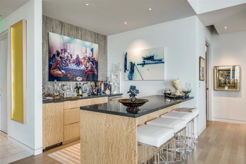 Our downtown gal about town clearly loves to entertain, and the striking wet bar invites guests to belly up. (Photo by Compass RE Texas)