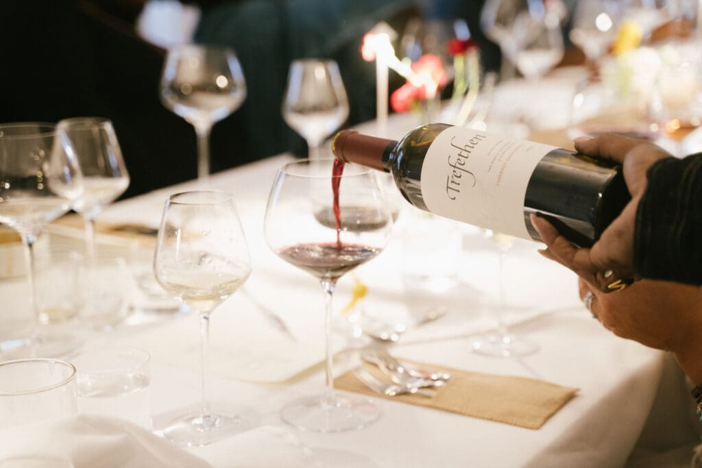 Wine from sommelier Monica Jones' curated selection is served to guests at Sips & Saddles: Supperclub Dinner at Hotel King Henry (Photo by NYC High Photography) 