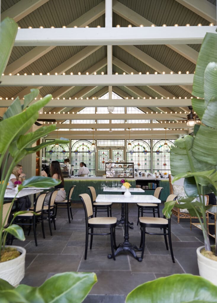 The Greenhouse Café, a stained-glass coffee shop nestled in the resort's brick-walled courtyard garden.