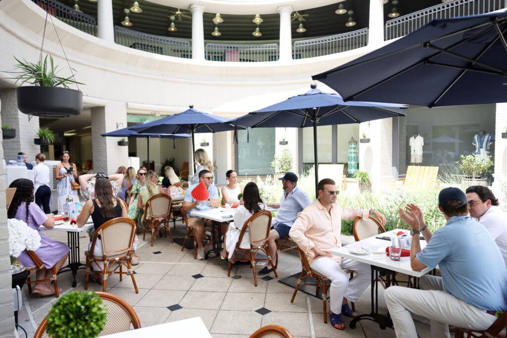 John Domolky, Trey McCord, Leon Brener and guests chill out on the patio, complete with portable AC units.