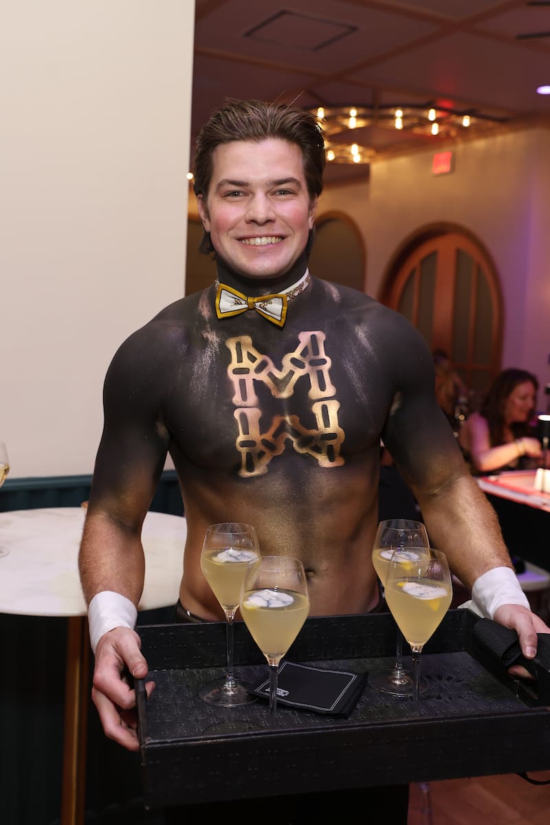 A sexy Mahjong Man serves Maj margaritas at the Mahjong for a Cure soirée. (Photo by Priscilla Dickson)