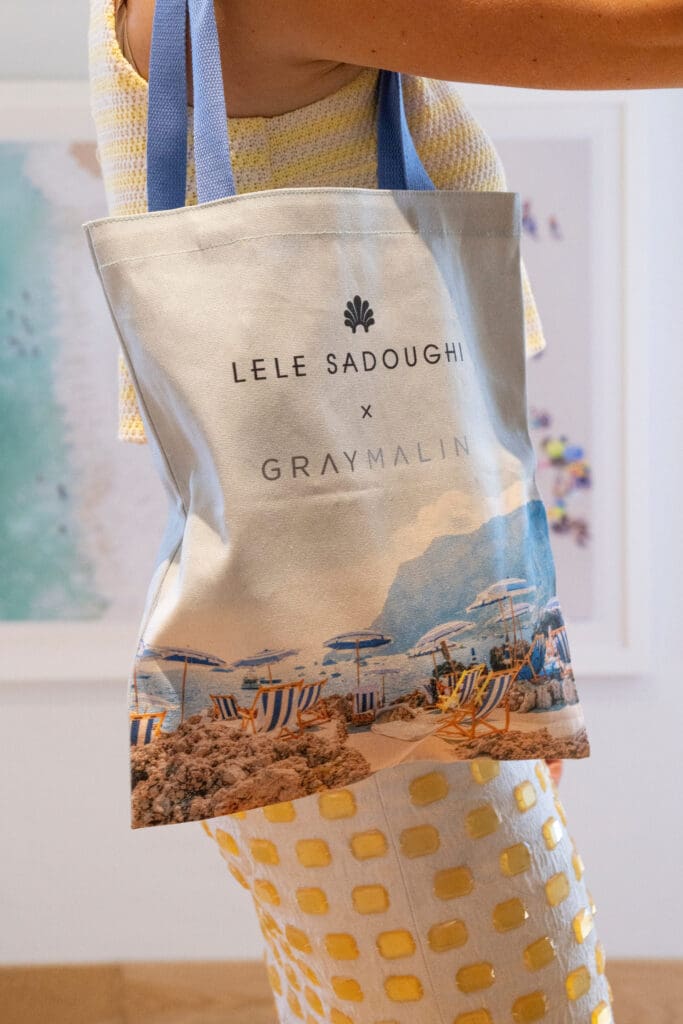Prices range from $50 for the La Fontelina Lucy Canvas Tote to $295 for the Bucket Bag, which also features a scene from Capri's iconic beach club. (Photo courtesy of Gray Malin)