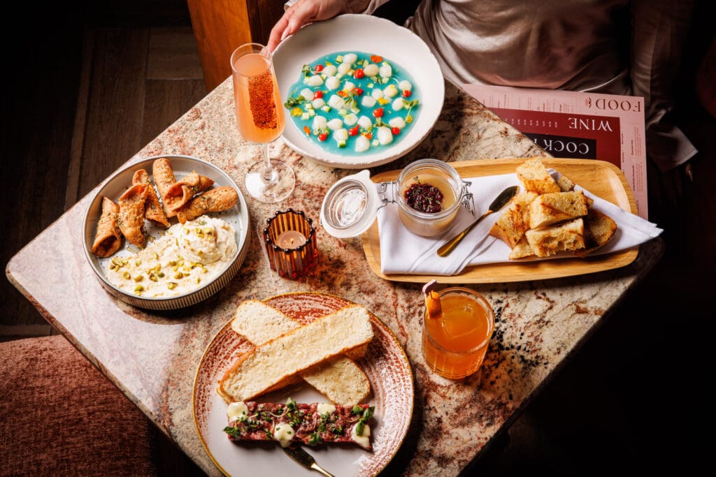 Flamant's food menu features small bites like faux gras, scallop crudo, savory cannoli dip, and more. (Photo by Samantha Marie)