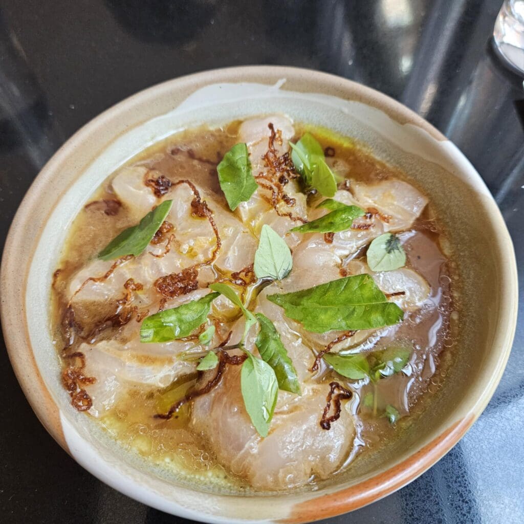 The Gulf Snapper Crudo at Duchess showcases fresh snapper with spicy lemon dressing, Texas olive oil, and crispy red onion. (Photo by Edward Brown)