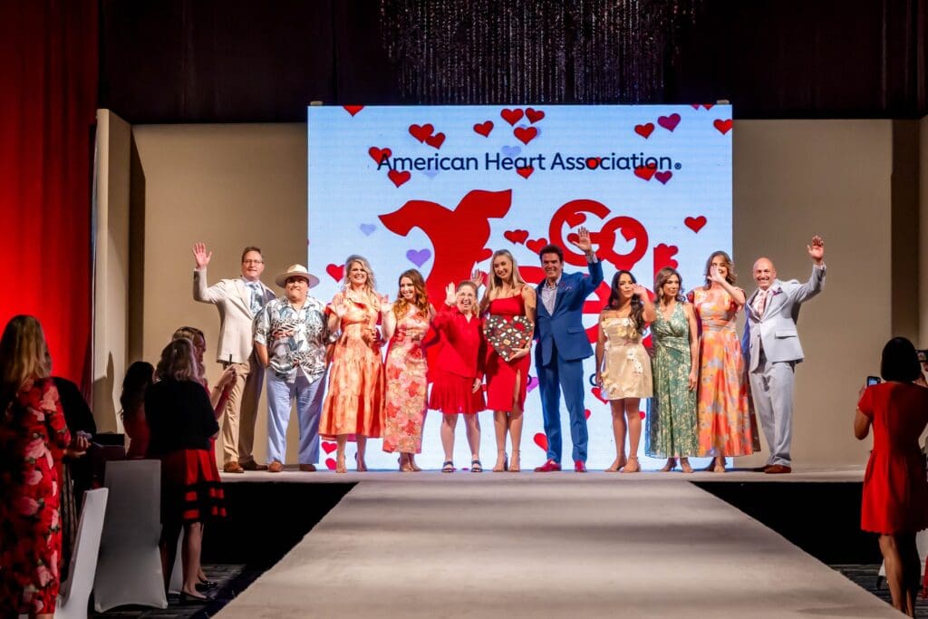 Survivor models Cary Attar, Jill Barber, Christine Domangue, Tim Joniec, Miguel Lopez, Taylor Parmigiano, Maria Flores and Nicole Tetreault walk the runway at the Montgomery County Go Red for Women Luncheon at The Woodlands Waterway Marriott. (Photo by Christina Griffin, WDR Imagery  )