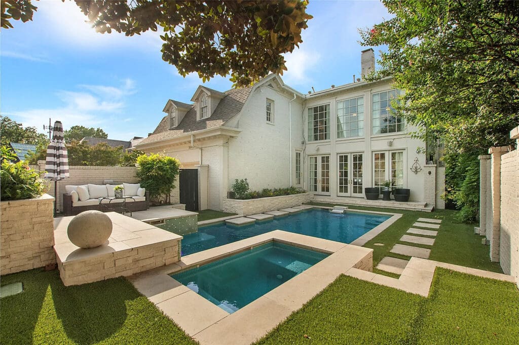 Highlights from the stately three-story brick home include soaring 10-foot ceilings, a chef's kitchen with a Wolf commercial range, and parquet flooring. (Courtesy of Allie Beth Allman & Associates)