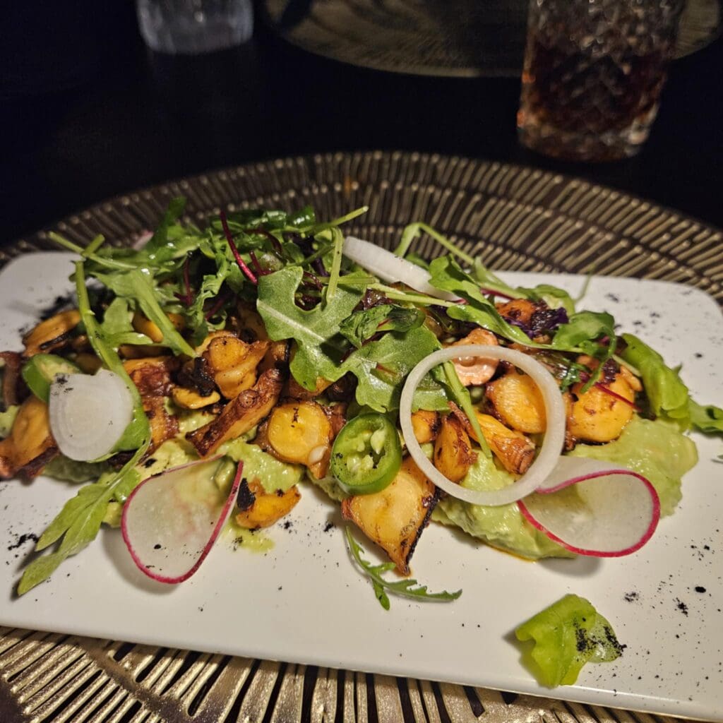 The Chicharrón Azteca at Polanco features grilled octopus with avocado mash, macha sauce, citrus, and fresh toppings. (Photo by Edward Brown)
