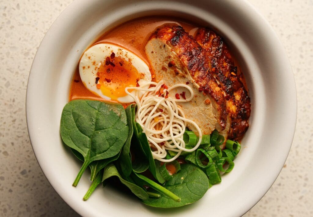 One of North India’s most popular exports, butter chicken, is reimagined here as butter chicken ramen ($24). Tender slices of chicken breast, soft-boiled egg, and ramen noodles are brought together in a lightened tomato and chicken stock broth. (Photo by Photos by Chris Furia)