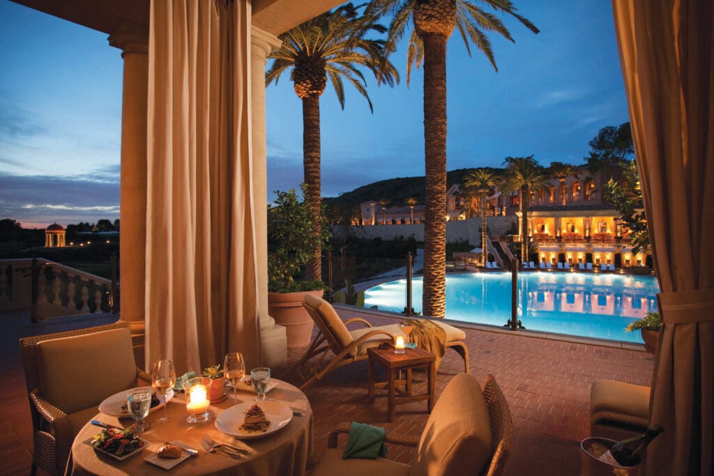 The Coliseum Pool & Grill overlooks sunbathers and "the scene" and is backdropped by the Pacific Ocean. (Photo by The Resort at Pelican Hill)