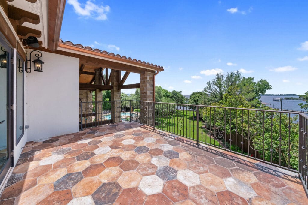 A spacious upstairs terrace offers panoramic views of Eagle Mountain Lake and the estate’s lush lawn below. (Photo by The Ashton Agency)