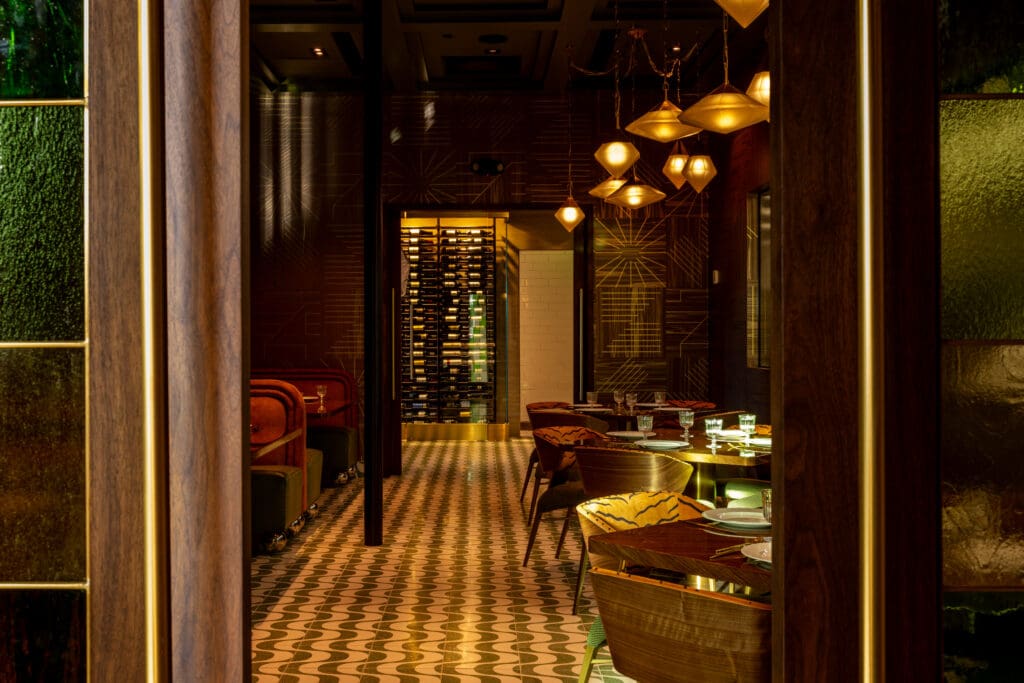 Plush booths, sculptural lighting, and rich finishes set the tone for refined dining at The Mont.   (Photo by Samantha Marie Photography)