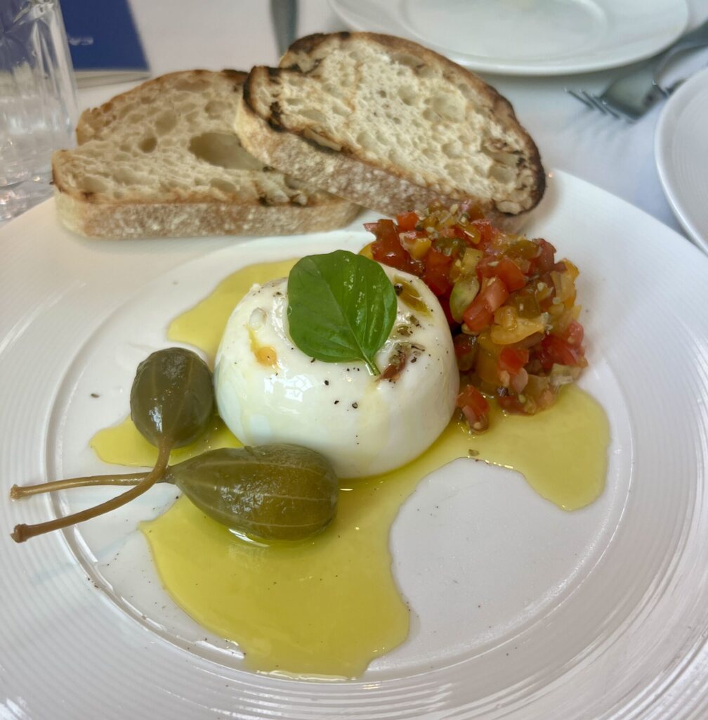 The burrata with tomatoes, basil, and giant capers is a must-try at Pane Nostro. (Photo by Megan Ziots)