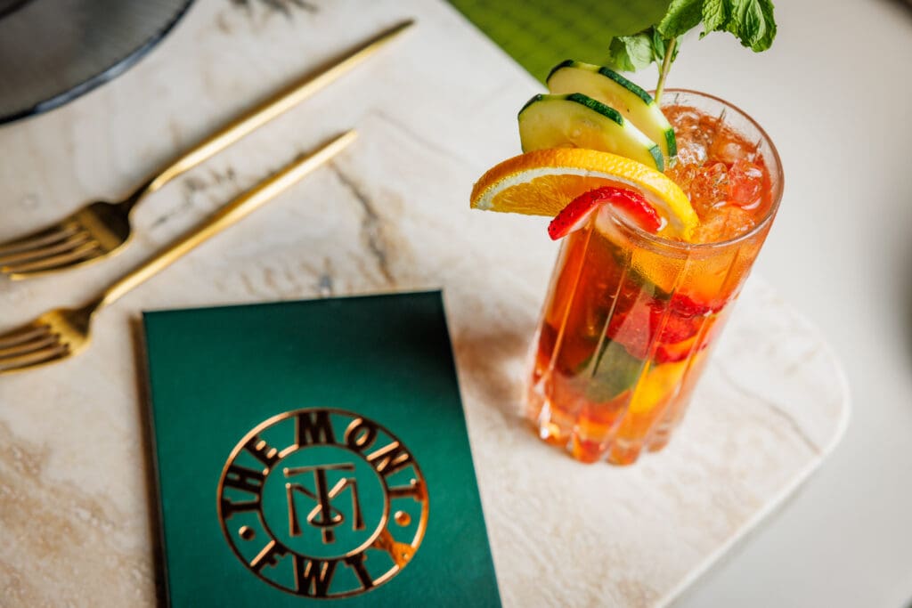The Kim’s Cup cocktail, a refreshing blend of fresh fruit, herbs, and spirits, served with signature Mont style.  (Photo by Samantha Marie Photography)