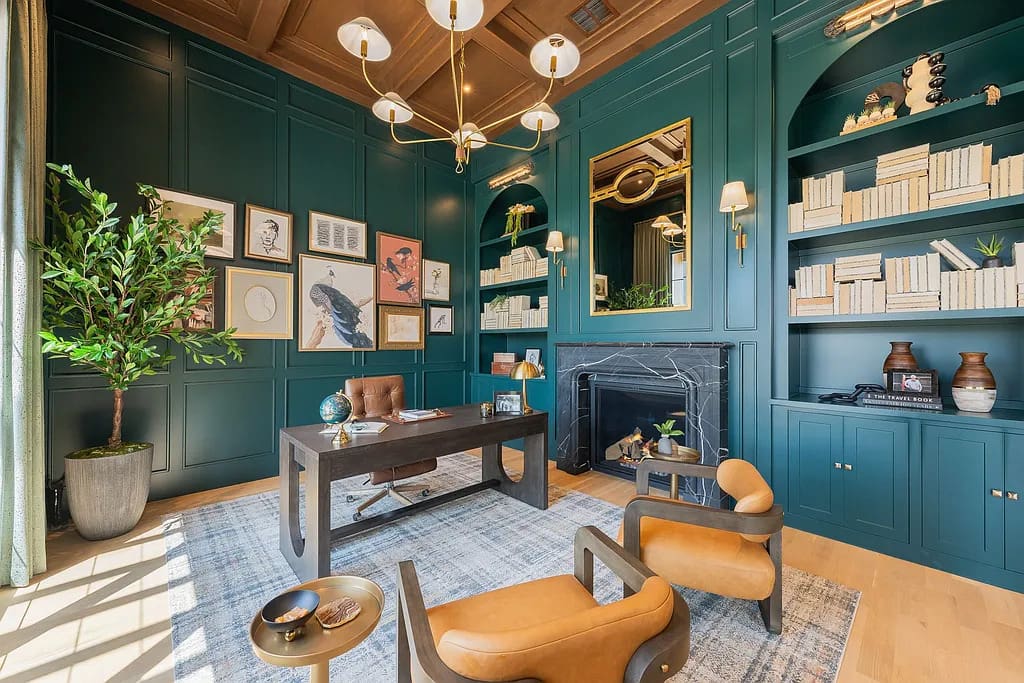 The home’s executive study is wrapped in rich millwork with floor-to-ceiling built-in shelving, a marble fireplace, and abundant natural light. (Courtesy)