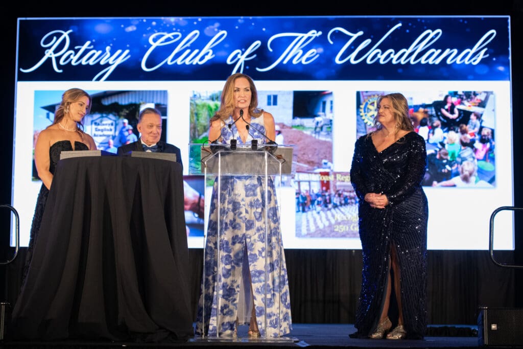 Cindy Heiser, president of The Rotary Club of The Woodlands, accepts recognition from YES to YOUTH at the gala with Lauren Janssen, William Malone Jr. and Michele Kooken.  (Photo by Tara Flannery)