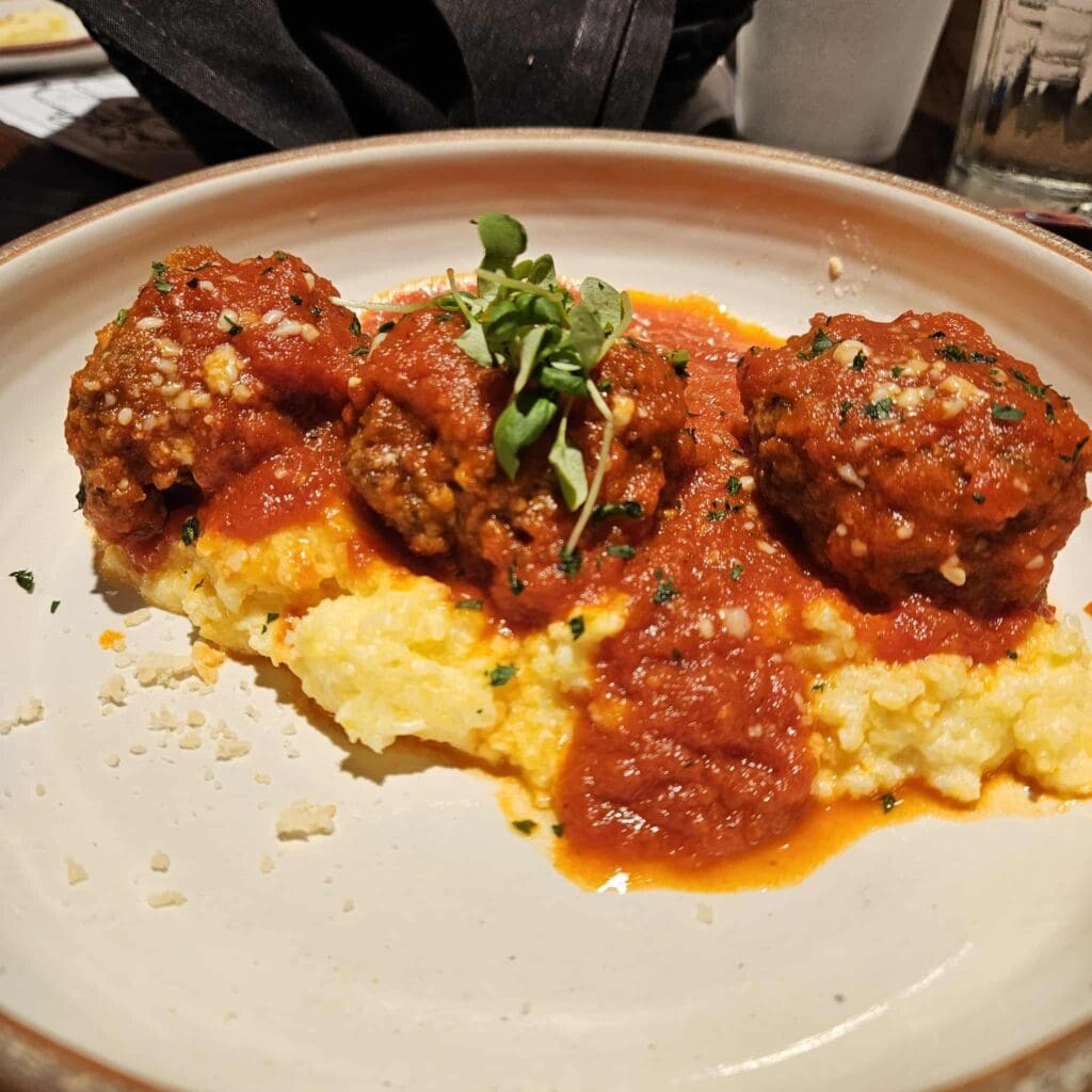 The Wagyu Meatballs at Cattlemen’s Steak House come out rich and tender over smoky, cheesy polenta with spicy marinara and parmesan. (Photo by Edward Brown)