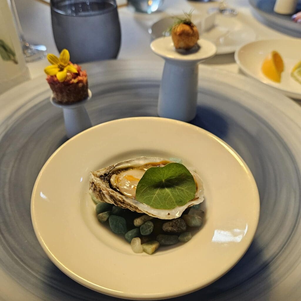 At The Crescent Hotel’s Blue Room, a triptych of Gulf oyster, artichoke beignet, and Wagyu croustade opens the meal with William Chris sparkling Sauvignon Blanc. (Photo by Edward Brown)
