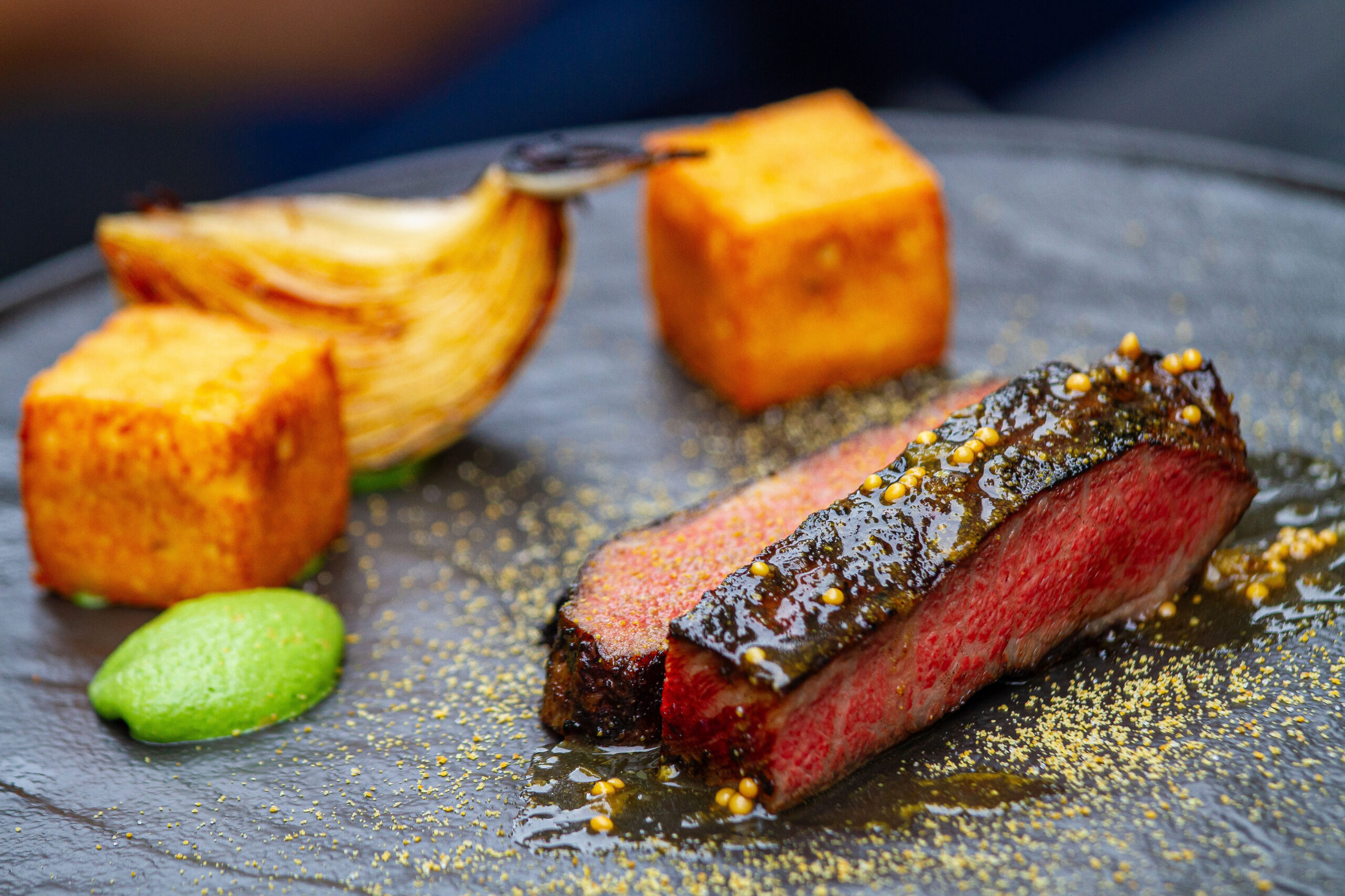 Texas Wagyu Flatiron with Grilled Onion, Olive Yassa and Crisp Potato. is the type of dish Tristen Epps whips up. (Photo by Charles Dante)