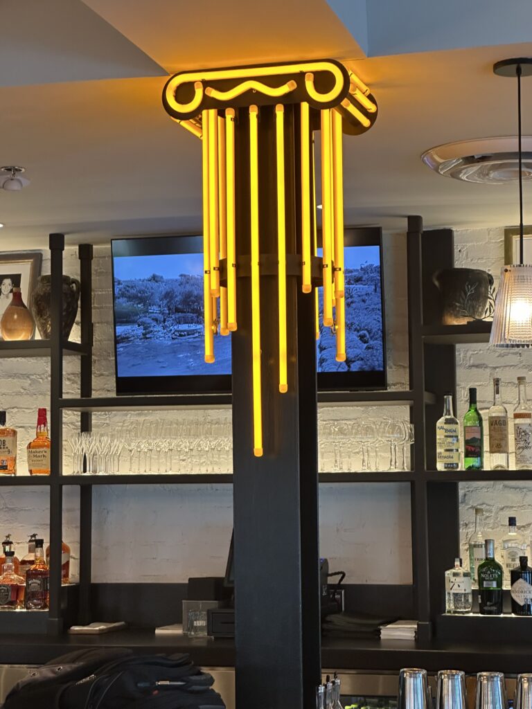 A neon Iconic column adds a note of fun to the bar in Yiayia's Greek Kitchen (Photo by Shelby Hodge)