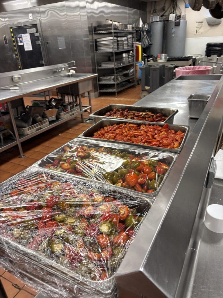 Trays of vegetables are prepped and wrapped in the Marriott kitchen ahead of the YES for YOUTH gala tasting. (Photo courtesy The Woodlands Waterway Marriott)