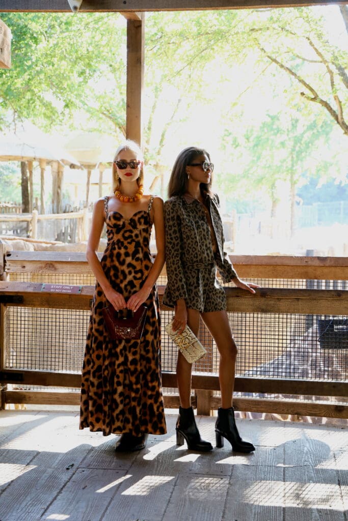 (Left) Leopard dress by L’Agence, styled with matching leopard shoes from Santoni. A bold orange necklace from Patricia Von Musulin, chic Tom Ford sunglasses, and a sculptural Rocío bag complete the statement.(Right) A leopard jacket-and-short set by L’Agence, layered over a brown/bronze button-up shirt from L’Agence. Paired with a sleek Valentino bag and modern frames by Thierry Lasry.