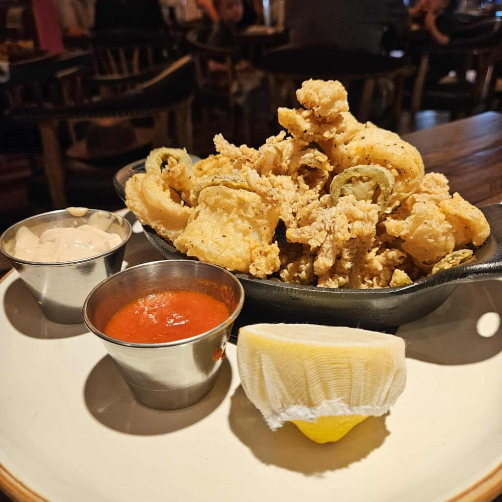 The Wrangler Calamari at Cattlemen’s Steak House comes crisp and golden, paired with fried jalapeños, tartar, and marinara. (Photo by Edward Brown)