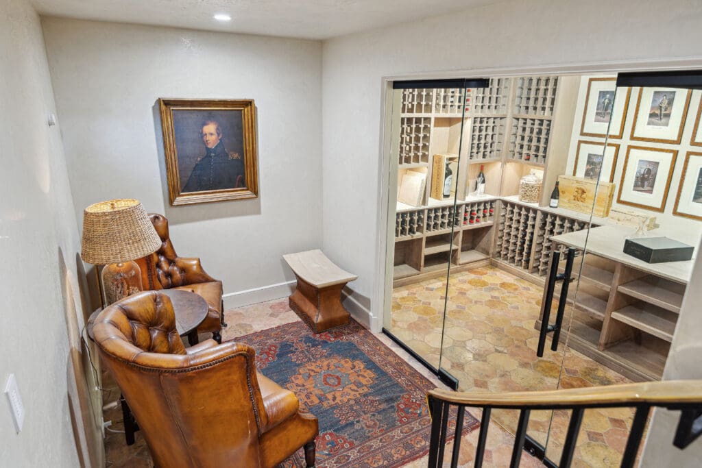 Stairs from the a gourmet kitchen lead to a temperature-controlled wine cellar and office nook, custom closets, marble-clad bathrooms, and more beckon.