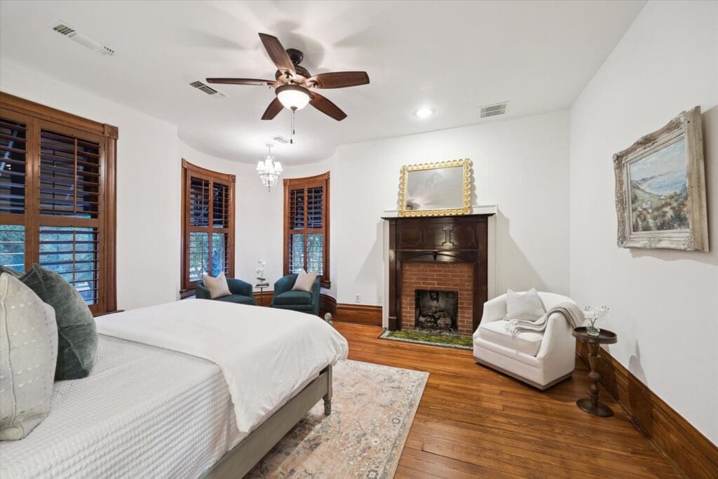 The bedroom has one of the two fireplaces in the home at 1011 Heights Blvd. (Photo by TK Images)
