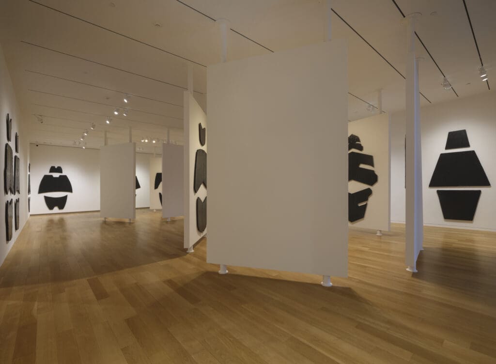 Installed like a field of totems, the towering works surround visitors in campsite-like clusters, transforming Lamborghini hoods into figures of myth and ritual. (Photo by The Modern Art Museum of Fort Worth )
