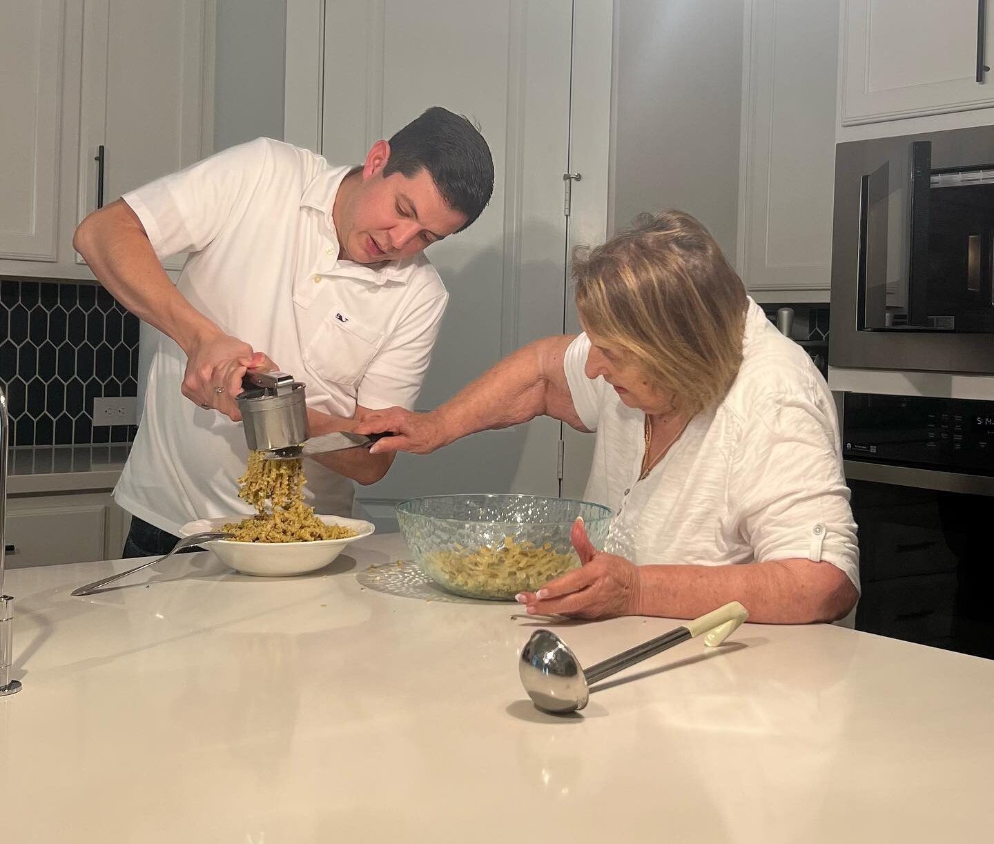 Enrique helping Nonna w_ Passatelli (Photo by Sherri Segari)