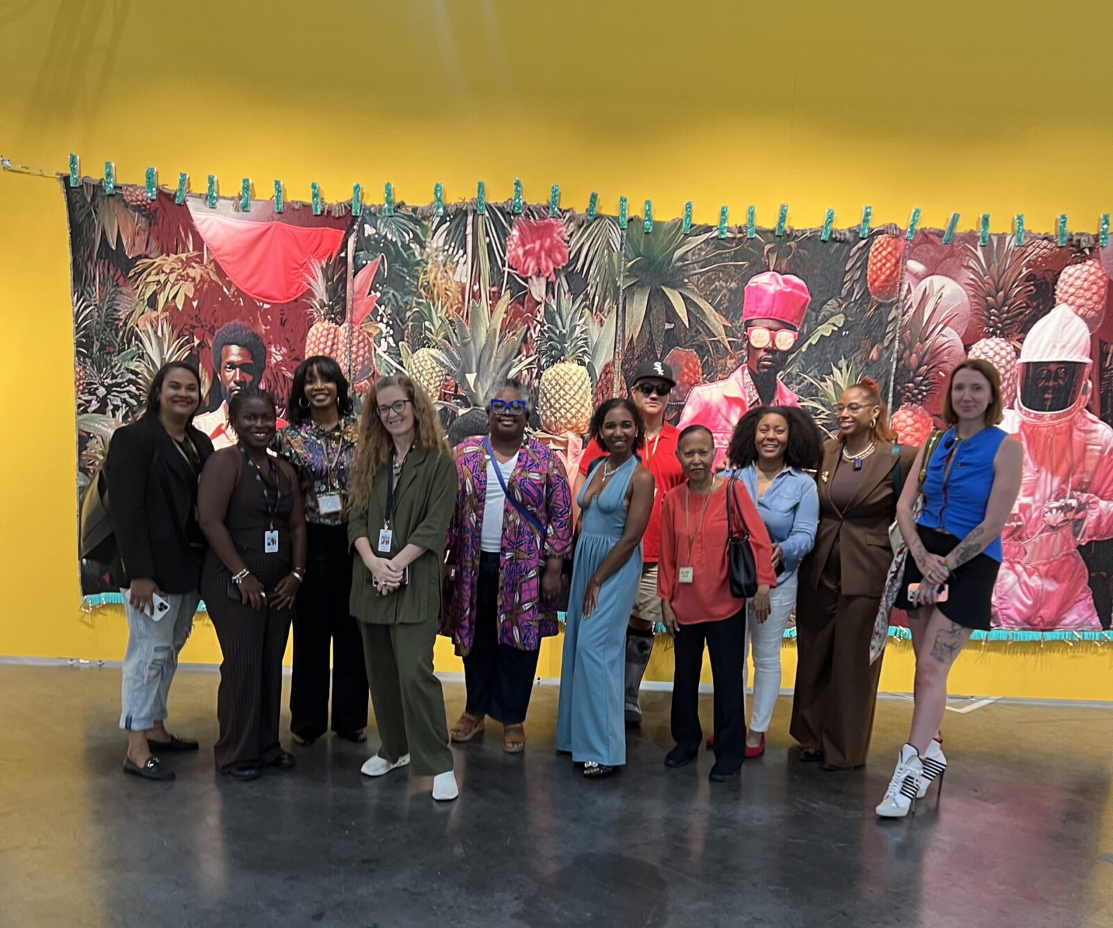 GloryLand's Moriah Alise, second from right, leads a tour of Untitled Art, Houston, 2025. Shown here, Tern Gallery's booth with a heroic work by April Bey.Shown here, Tern Gallery's booth with a heroic work by April Bey.