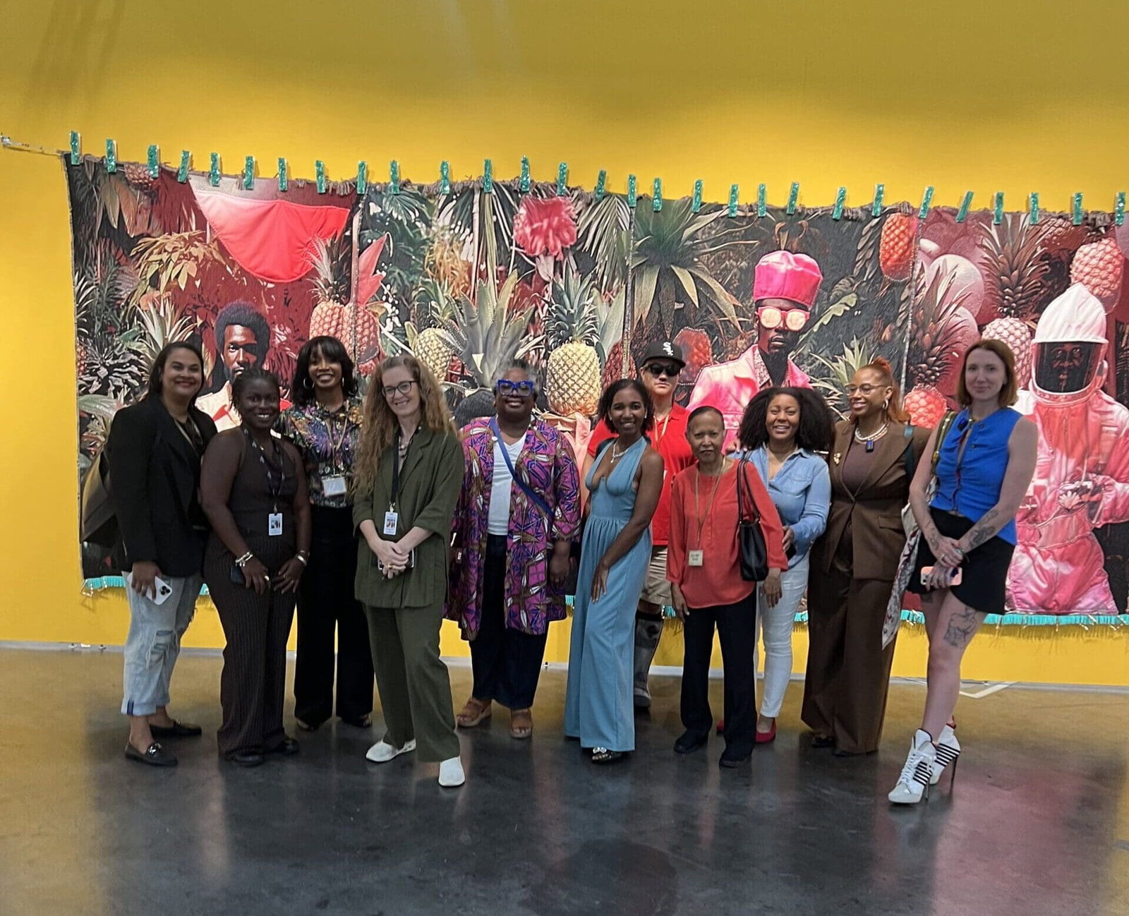 GloryLand led by Moriah Alise, second from right, with her art group leads a tour of Untitled Art, Houston, 2025 Shown here, in Tern Gallery's booth with a heroic work by April Bey.