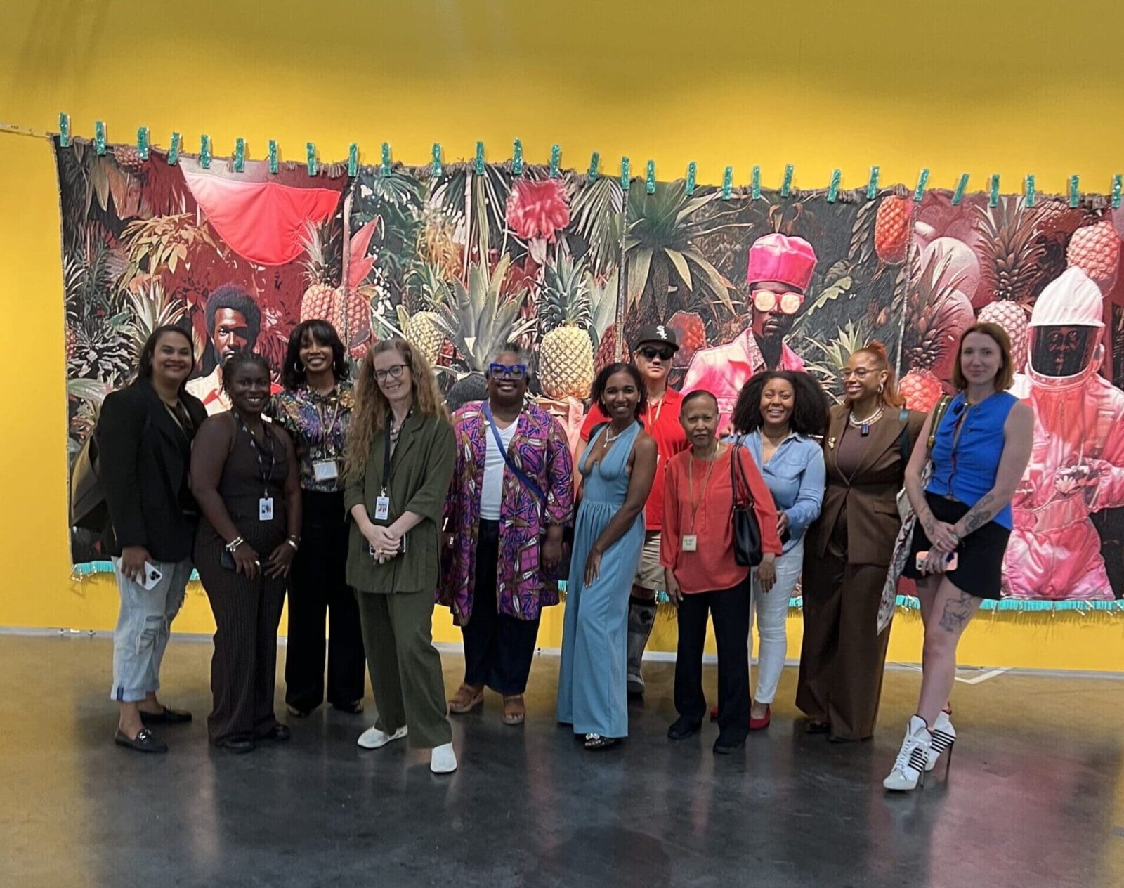 GloryLand's Moriah Alise, second from right, leads a tour of Untitled Art, Houston, 2025. Shown here, Tern Gallery's booth with a heroic work by April Bey.Shown here, Tern Gallery's booth with a heroic work by April Bey.