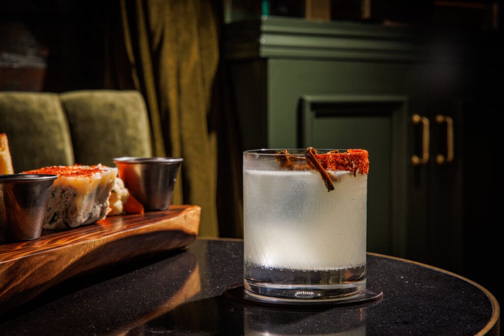 For spice lovers, Caché's Holy Trinity is made with mezcal, poblano liqueur, and bell pepper oleo. (Photo by Samantha Marie Photography)