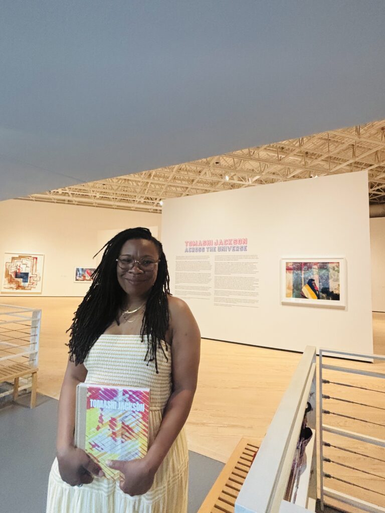 Artist Tomashi Jackson holds a copy of the catalogue for her exhibit "Tomashi Jackson: Across the Universe," on view through March 29 at Contemporary Arts Museum Houston. (Photo by Ericka Schiche)