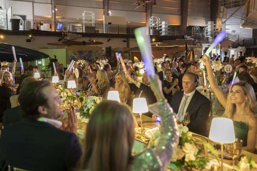 Guests raise their paddles in support of SPCA of Texas. (Photo by Thomas Garza)